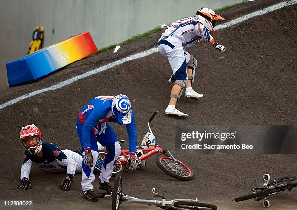 Raymon Van Der Biezen of the Netherlands, top, crashes and takes down Kyle Bennett of the United States, bottom, and Michal Prokop of the Czech...