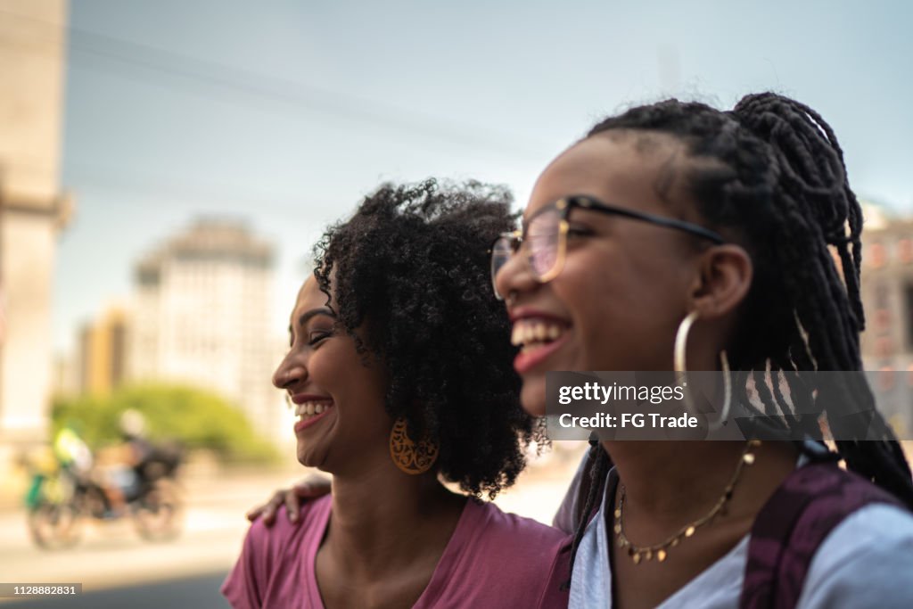 Afro young women in the city walking