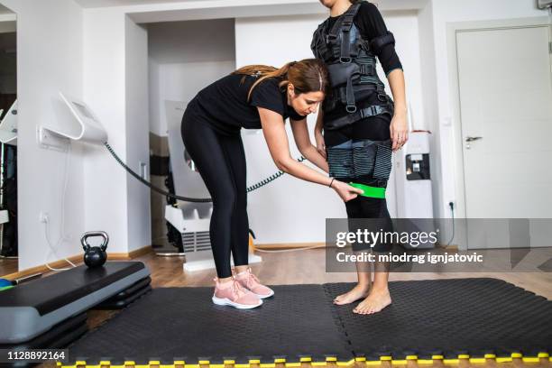 fitness trainer at ems training - neuromuscular system stock pictures, royalty-free photos & images
