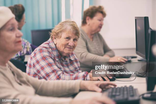 senior women are computer students. - elderly classroom stock pictures, royalty-free photos & images