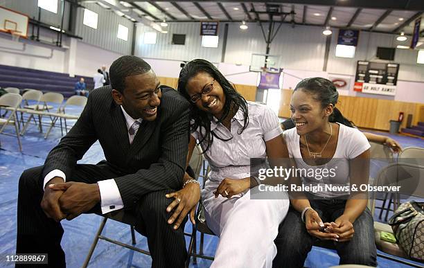 John Wall laughs with his sisters Tonya Pulley, center, and Cierra Wall, right, after a press conference at Word of God Christian Academy on...