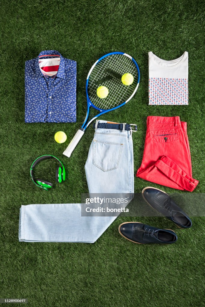 Men’s clothing with personal accesorries isolated on grass background
