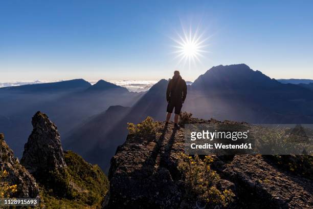 reunion, reunion national park, maido viewpoint, view from vulcano maido to cirque de mafate, gros morne and piton des neiges, male hiker - la reunion stock pictures, royalty-free photos & images