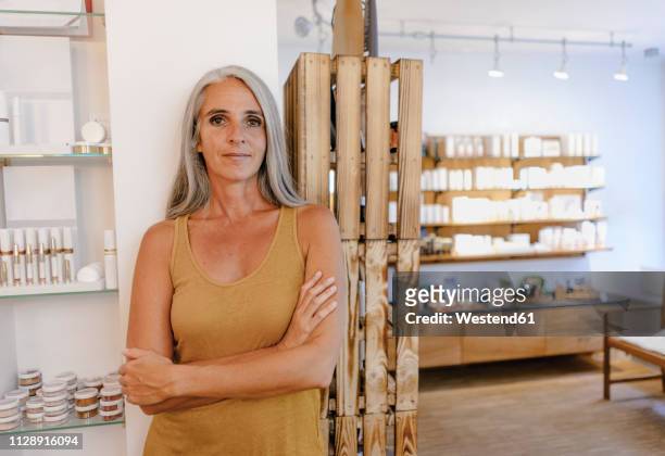 portrait of businesswoman in her shop - cosmetic sales woman stock-fotos und bilder