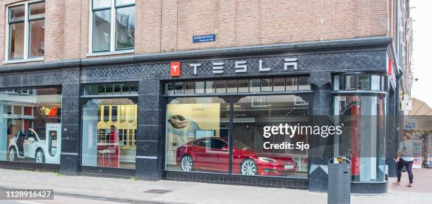 tesla showroom with tesla model s and x electric cars - tesla model s stock pictures, royalty-free photos & images