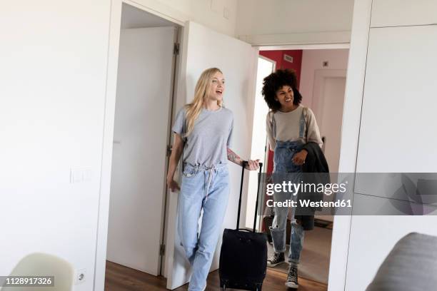 two happy women with baggage arriving in accomodation - the girlfriend stock pictures, royalty-free photos & images