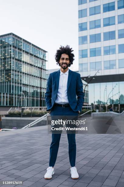 spain, barcelona, portrait of stylish young businessman standing in the city - the standing men stock pictures, royalty-free photos & images