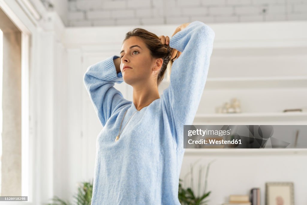 Pensive young woman wearing pullover