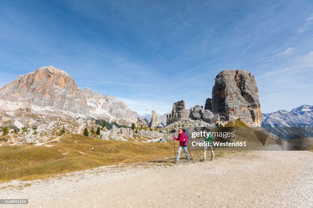 Italy, Cortina d'Ampezzo, two people hiking in the Dolomites mountain area