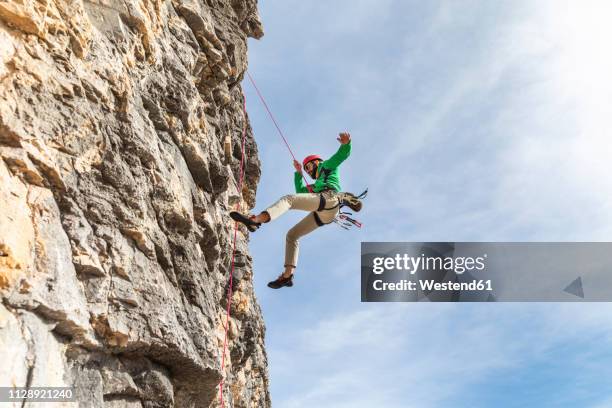 italy, cortina d'ampezzo, man abseiling in the dolomites mountains - escalada libre fotografías e imágenes de stock