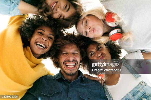 group portrait of cheerful friends huddling - celebration of life and laughter stock-fotos und bilder