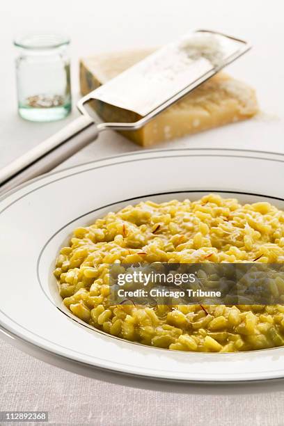 Risotto alla milanese, flavored with precious threads of saffron, is the second course Omella Marcante serves.