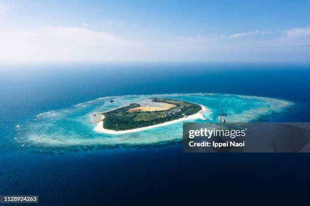 aerial view of tropical japanese island with coral reef and blue water, okinawa - okinawa blue sky beach landscape stock-fotos und bilder