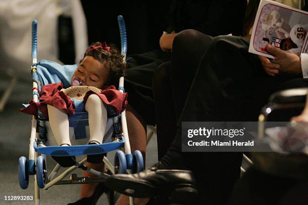 Jackie, Sean Taylor's young daughter, sleeps on her stroller minutes before the start of funeral services for Sean Taylor at the Pharmed Arena in the...