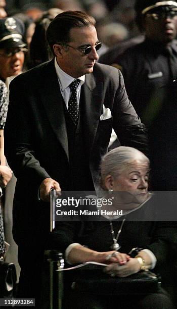 Andy Garcia wheels an unidentified woman into the Sean Taylor funeral service at the Pharmed Arena in the campus of Florida International University,...