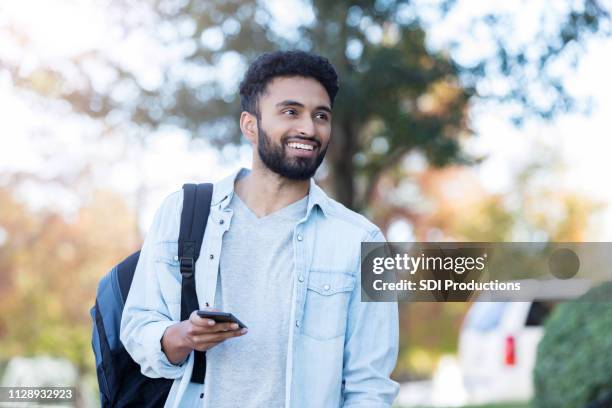 confident male college student on campus - asian american students college stock pictures, royalty-free photos & images