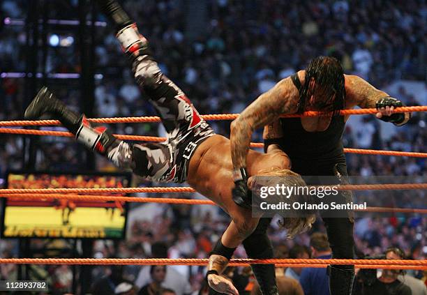 The Undertaker throws Edge out of the ring during WrestleMania XXIV at the Citrus Bowl on Sunday, March 30 in Orlando, Florida.