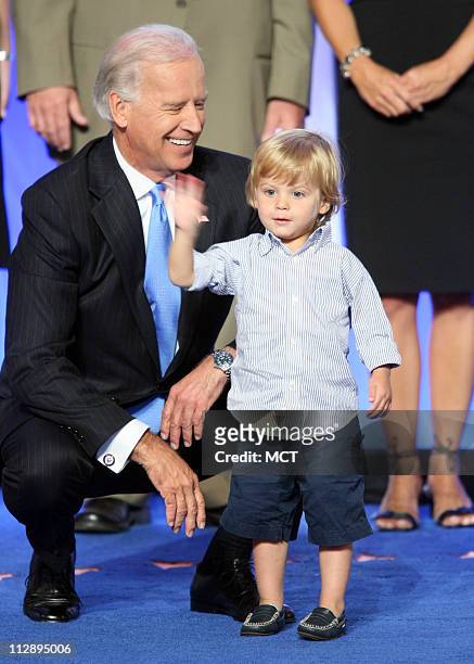 Sen. Joe Biden encourages his grandson, Hunter, to wave to the delegates at the Democratic National Convention in Denver, Colorado, Wednesday, August...