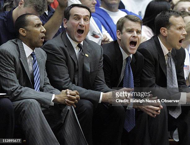 Duke head coach Mike Krzyzewski, second from left, and assistant coaches, from left, Johnny Dawkins, Steve Wojciechowski and Chris Collins react...