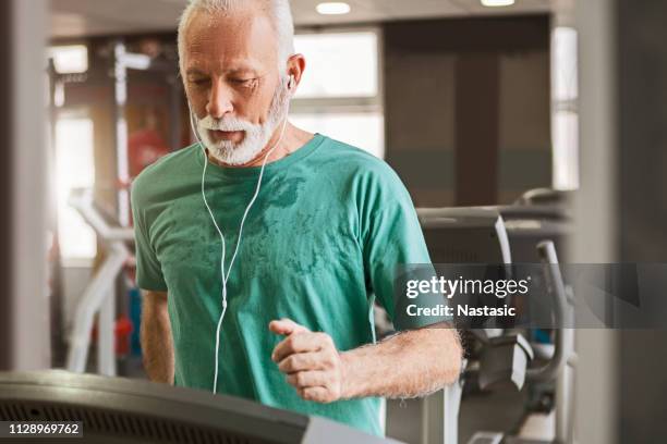 senior man training cardio on a treadmill - treadmill stock pictures, royalty-free photos & images
