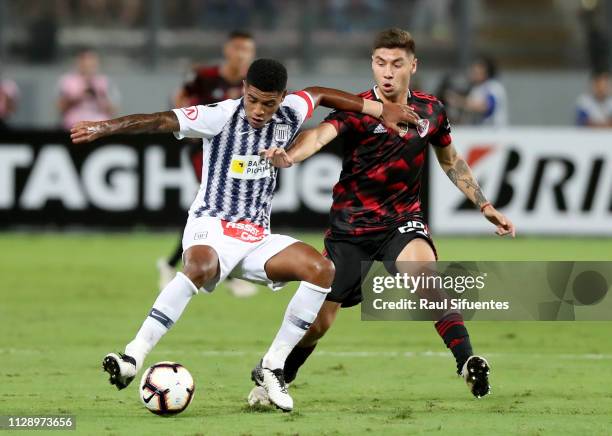 Wilder Cartagena of Alianza Lima struggles for the ball with Gonzalo Montiel of River Plate during a group A match between Alianza Lima and River...