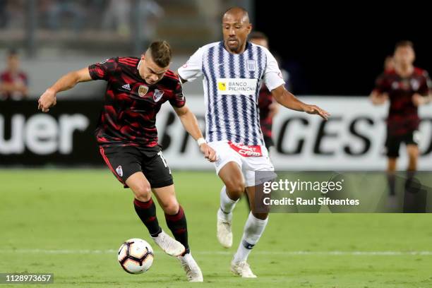 Rafael Santos Borre of River Plate struggles for the ball with Luis Ramirez of Alianza Lima during a group A match between Alianza Lima and River...