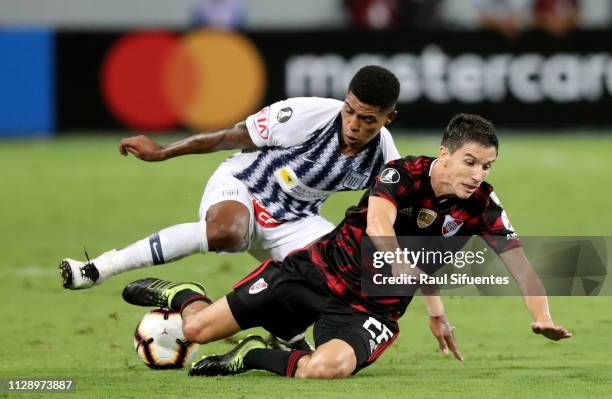 Ignacio Fernandez of River Plate struggles for the ball with Wilder Cartagena of Alianza Lima during a group A match between Alianza Lima and River...