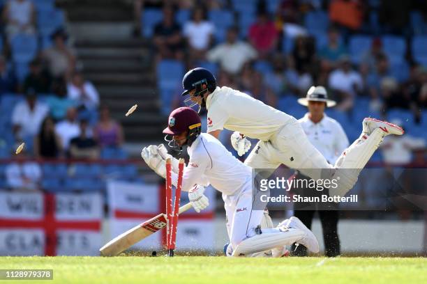 Joe Root of England makes his ground as Shane Dowrich of the West Indies takes the bails off during Day Three of the Third Test match between the...