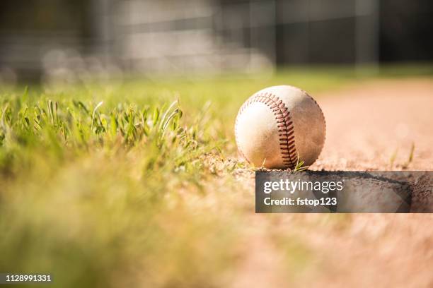 baseball season is here.  weathered ball on field. - baseball field background stock pictures, royalty-free photos & images