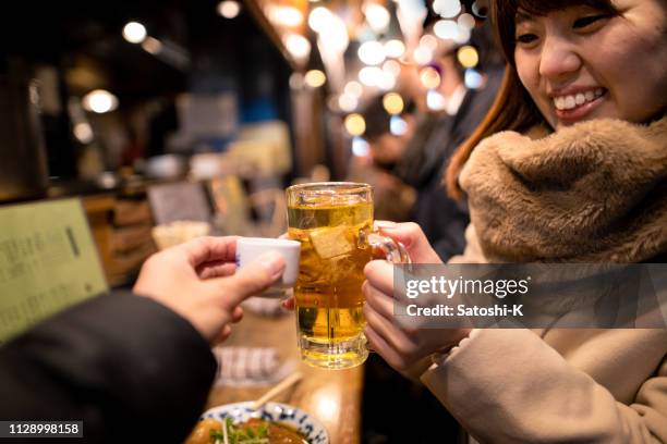 二人は屋外立ち飲み居酒屋バーで乾杯 - restaurant night ストックフォトと画像