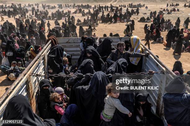 Women and children evacuated from the Islamic State group's embattled holdout of Baghouz arrive at a screening area held by the US-backed Kurdish-led...