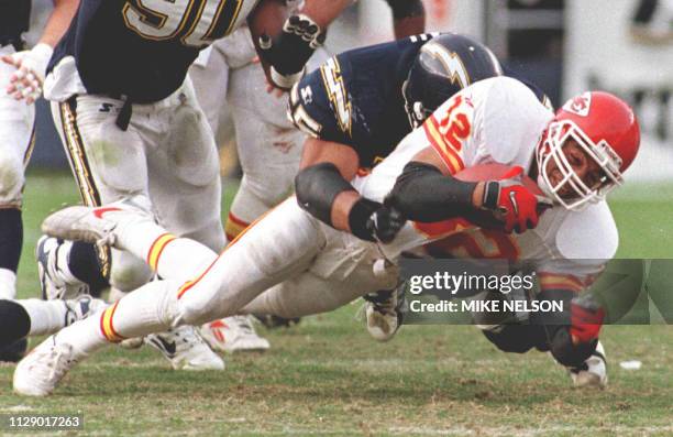 Kansas City Chiefs running back Marcus Allen is brought down by San Diego Chargers Junior Seau after a short gain in the 3rd quarter 14 December....