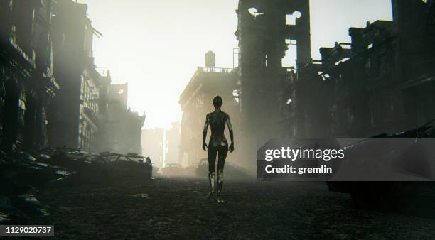 futuristic cyborg walking in destroyed city - apocalypse stock pictures, royalty-free photos & images