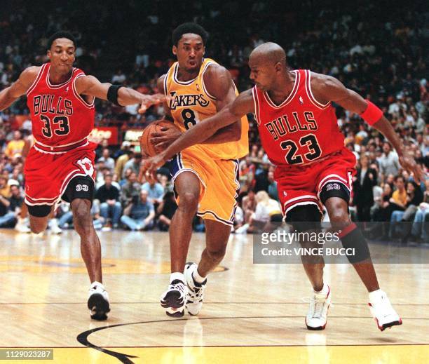 Scottie Pippen and Michael Jordan of the Chicago Bulls try to stop Kobe Bryant of the Los Angeles Lakers as he leads a fast break during their 01...