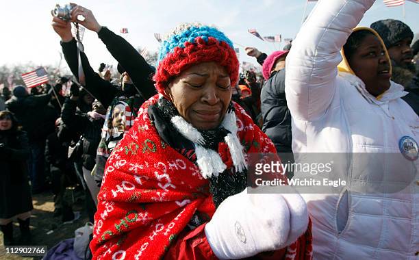 Wearing socks on her hands to keep warm, Elaine WIlliams of Westfield, Massachusets, cries during President Barack Obama's inaugural address in...