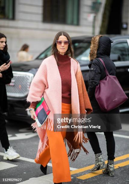 Guest is seen wearing scarf worn as cape outside Carolina Herrera during New York Fashion Week Autumn Winter 2019 on February 11, 2019 in New York...