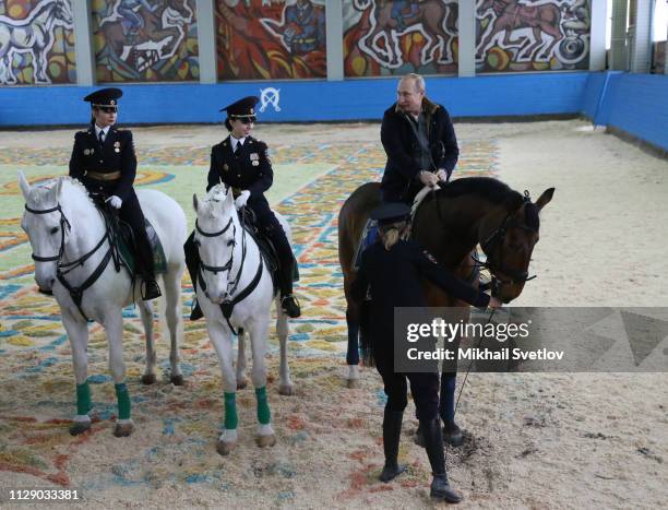 Russian President Vladimir Putin rides a horse while visiting the mounted police department on March 7, 2019 in in Moscow, Russia. Putin...