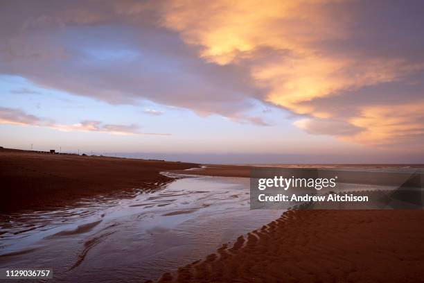 Winter sunset red sky over the long sandy beach of Sutton on Sea, Lincolnshire. United Kingdom. Sutton on Sea is on the coast of the North Sea, and...