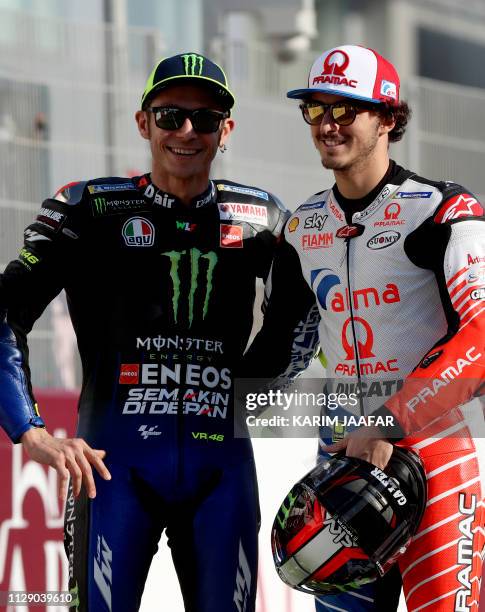 Italian MotoGp riders Yamaha MotoGP's Valentino Rossi and Alma Pramac Racing's Francesco Bagnaia pose together after a group picture in Doha on March...