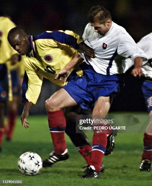 Colombian soccer player Johnier Montano goes for the ball along with Robert Hanko, of the Czech team, in Bogota, Colombia, 19 November 1999. El...