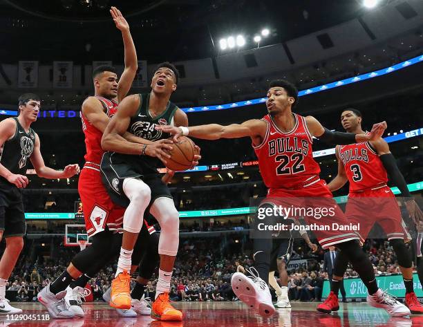 Giannis Antetokounmpo of the Milwaukee Bucks tries to get off a shot between Timothe Luwawu-Cabarrot and Otto Porter Jr. #22 of the Chicago Bulls at...