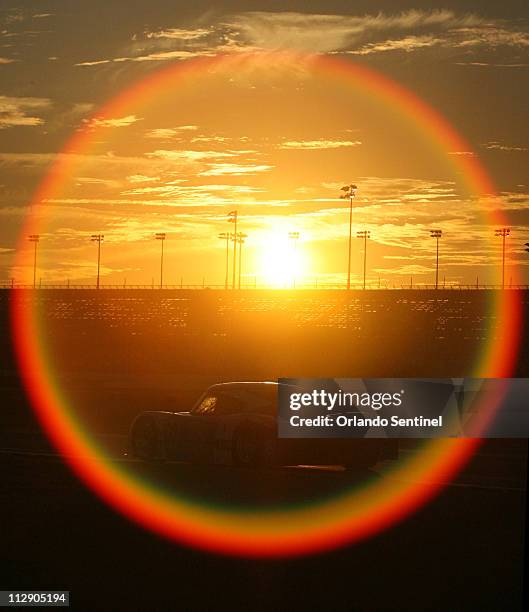 Chip Ganassi's 02 car drives into the sunset during the Rolex 24 Hour auto race at Daytona International Speedway in Daytona Beach, Florida,...