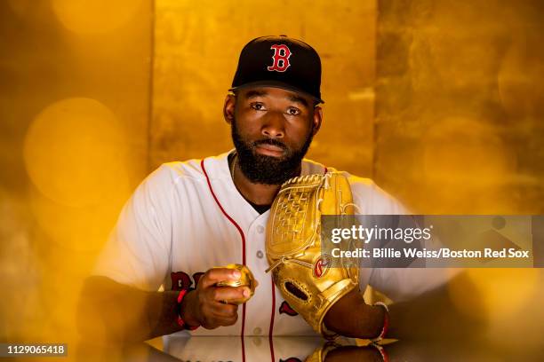 Jackie Bradley Jr. #19 of the Boston Red Sox poses for a portrait with the Gold Glove award during a team workout on February 27, 2019 at JetBlue...