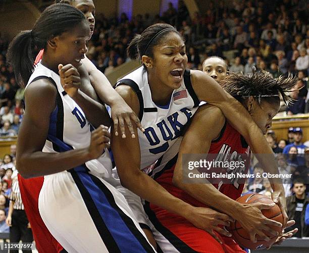 North Carolina State's Khadijah Whittington, right, wrestles a defensive rebound from Duke's Krystal Thomas, as Bridgette Mitchell looks on during...