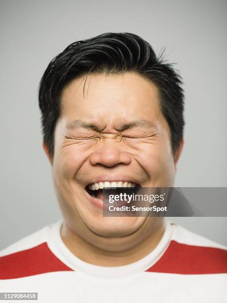 real chinese young man with very excited expression and closed eyes - mouth shouting stock pictures, royalty-free photos & images