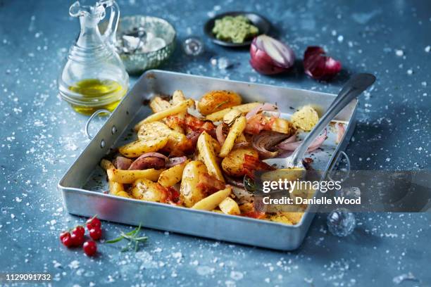 roasted vegetables with red onions in roasting tin, seasonal christmas food - tuber stock pictures, royalty-free photos & images