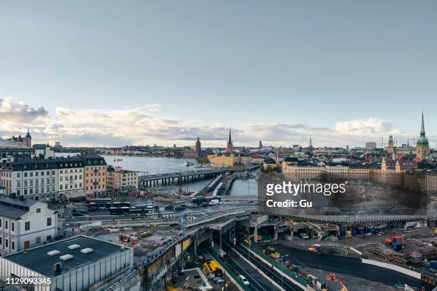 bridges, railway tracks, church tower, cityscape and water canal, stockholm, sweden - stockholm fotografías e imágenes de stock