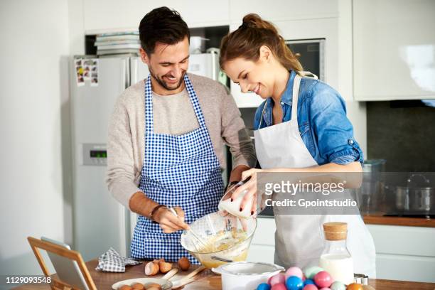 couple baking in kitchen - man baking cookies stock pictures, royalty-free photos & images
