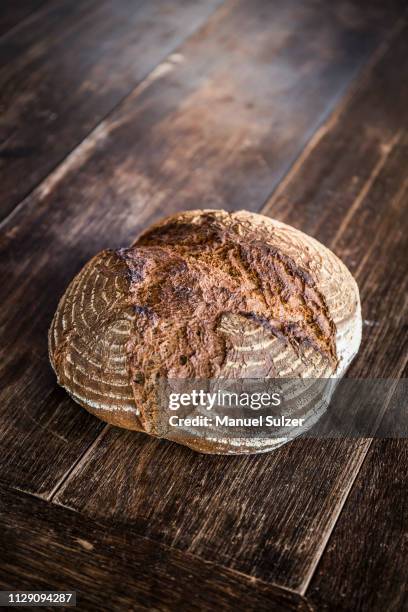 sourdough loaf on wooden table - soda bread stock pictures, royalty-free photos & images