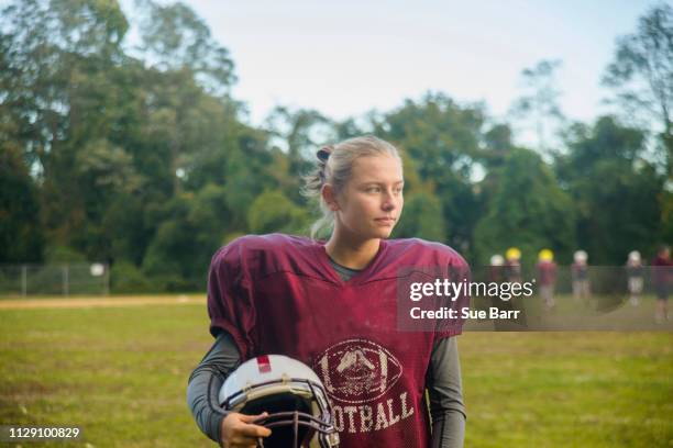 teenage female football player on field - girl american football player stock pictures, royalty-free photos & images